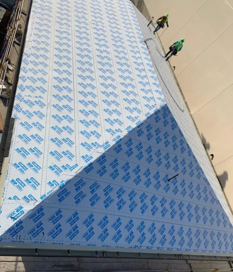 Professional roofers installing underlayment on a metal roof in Alta Sierra